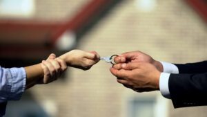 Man and woman pulling house key after divorce
