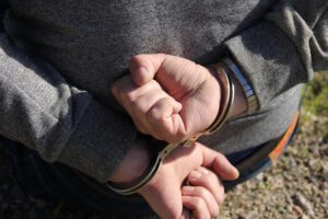 Criminal defense in Galveston. Man in handcuffs.