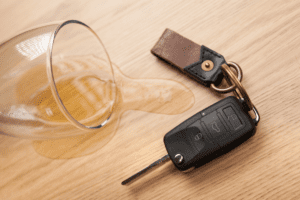 DUI lawyer in Dickinson, TX. Spilled glass of beer next to car keys.