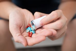 Woman with medication in her hands. Woman with medication in her hands.